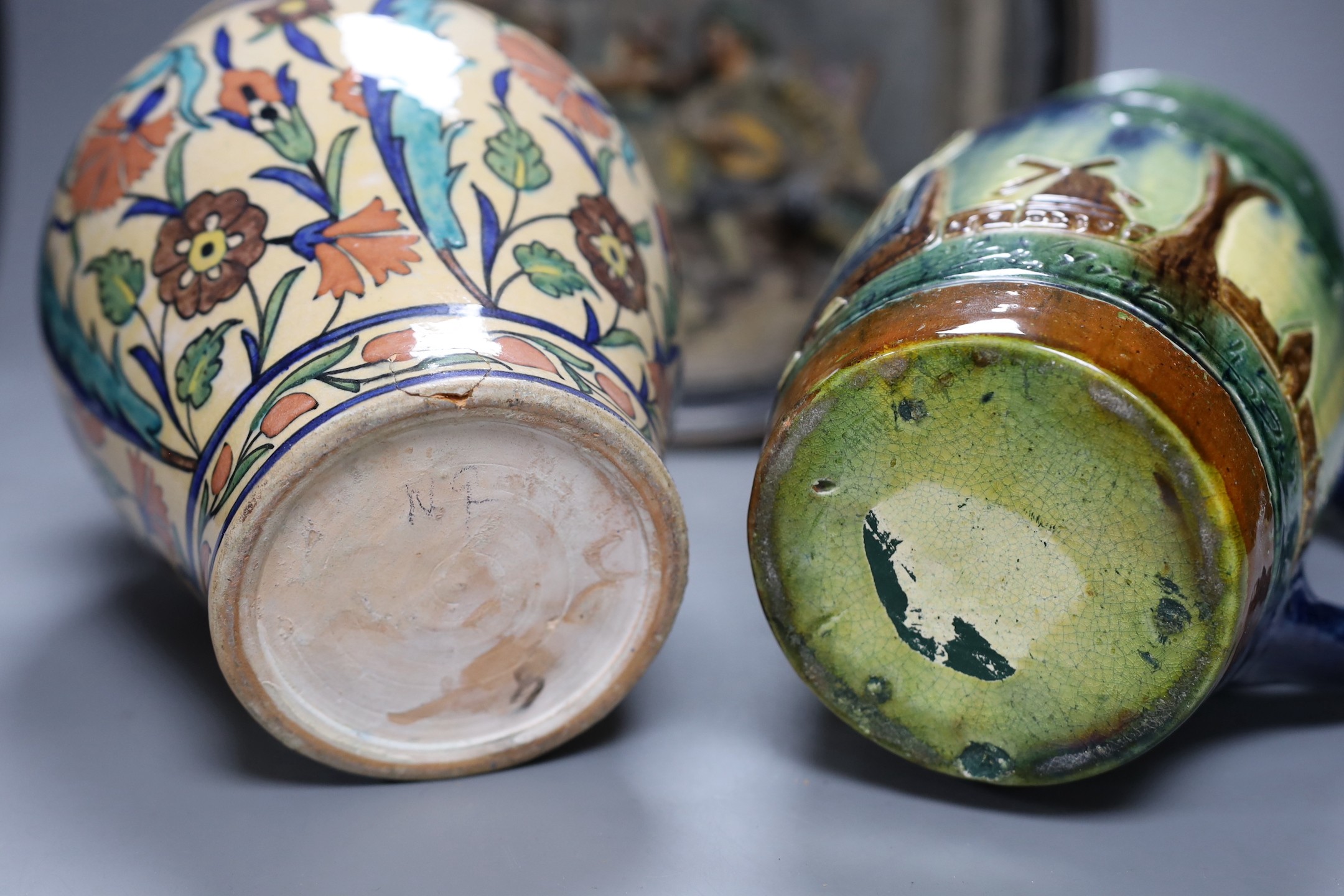 A Dutch jug, a polychrome vase and a Maresch Musterschutz moulded wall plaque, 33 cm diameter